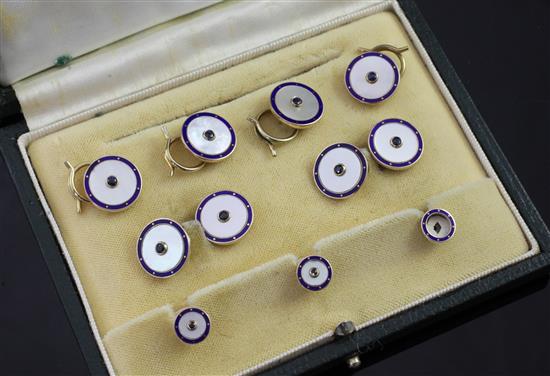 A cased modern 9ct gold, mother of pearl, enamel and sapphire set nine piece dress stud set,
